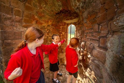 School children exploring Kenilworth Castle in Warwickshire